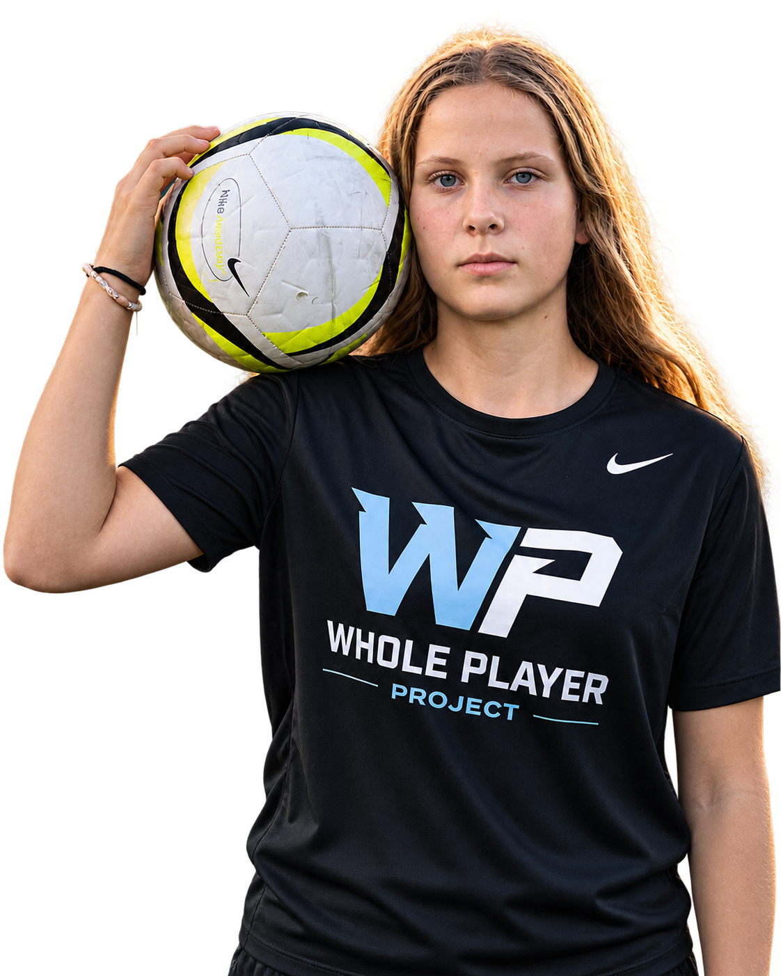 Young woman soccer player in a black Whole Player Project shirt holding a ball on her shoulder
